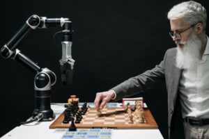 Man and robot arm play chess game.