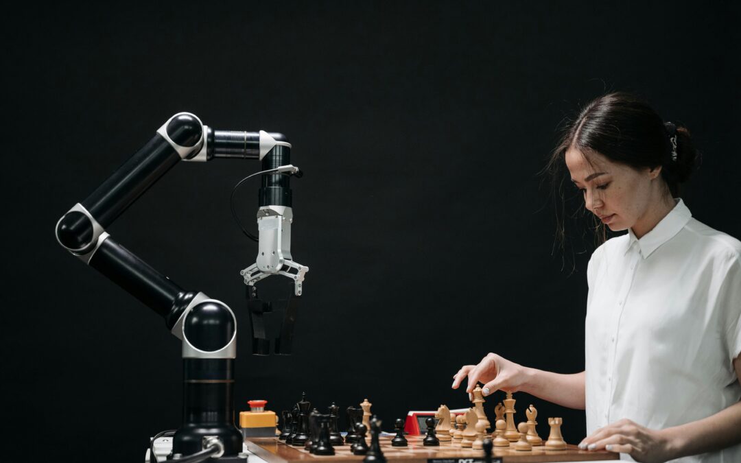 Robot arm playing chess with woman.