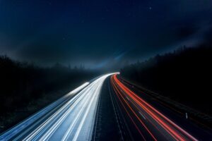 Night highway with car light trails