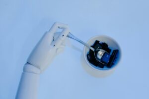 Robot hand holding spoon in keyboard bowl